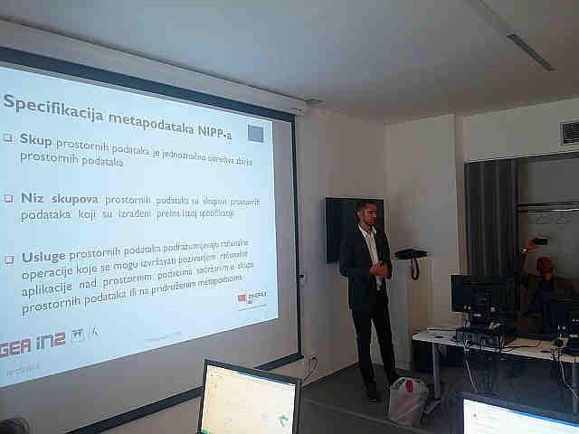 The picture shows the presentation of the NSDI Geoportal by IGEA company.